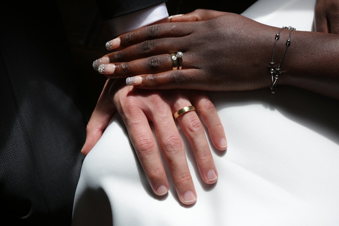 person wearing gold ring and gold ring