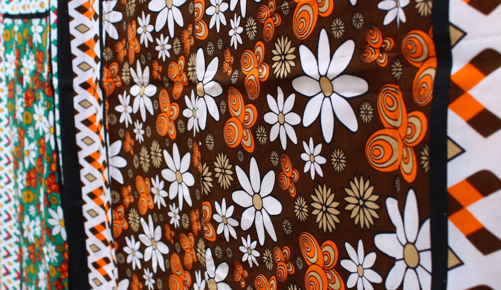 orange white and black floral textile