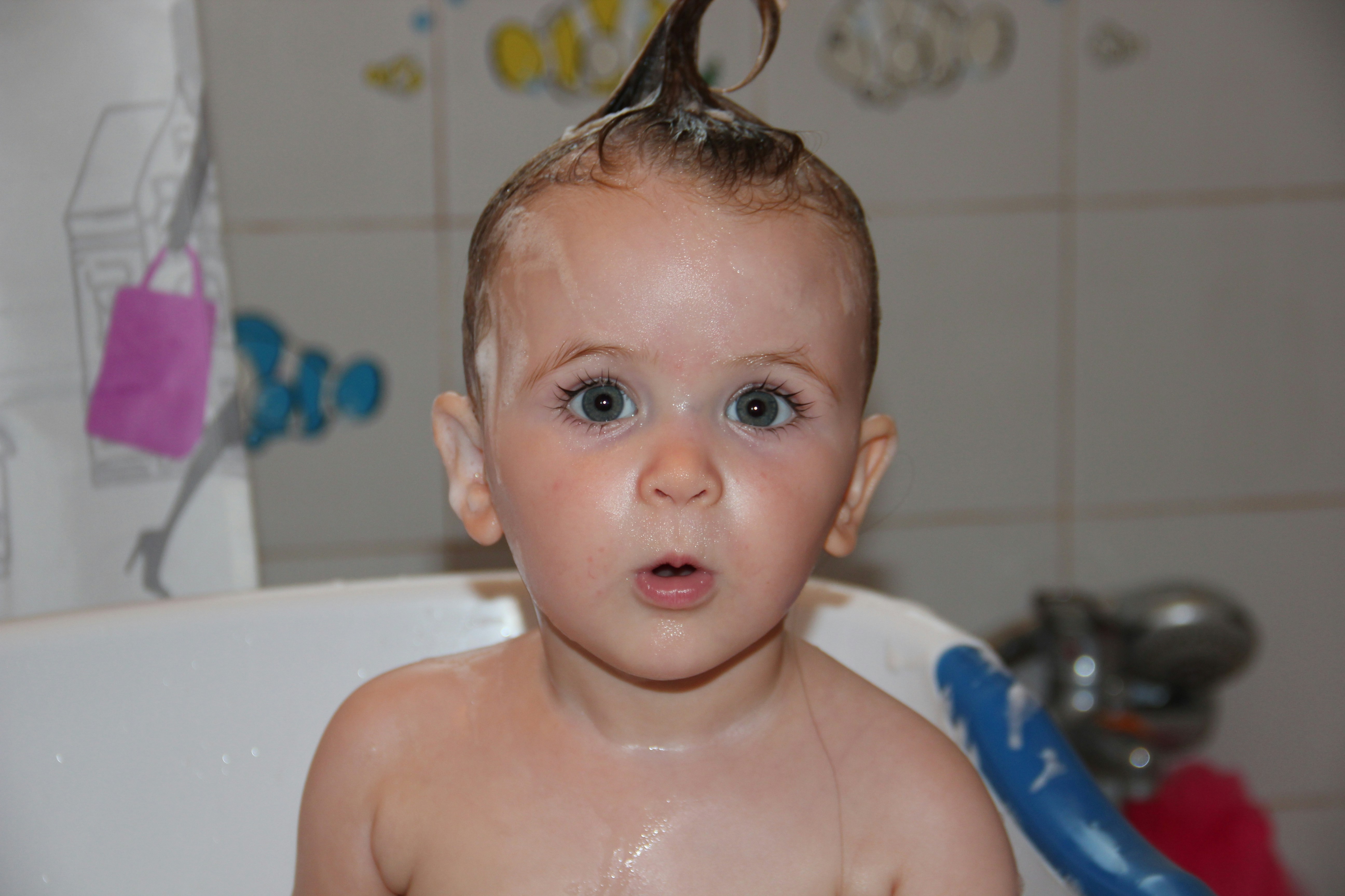 baby in white bathtub with water