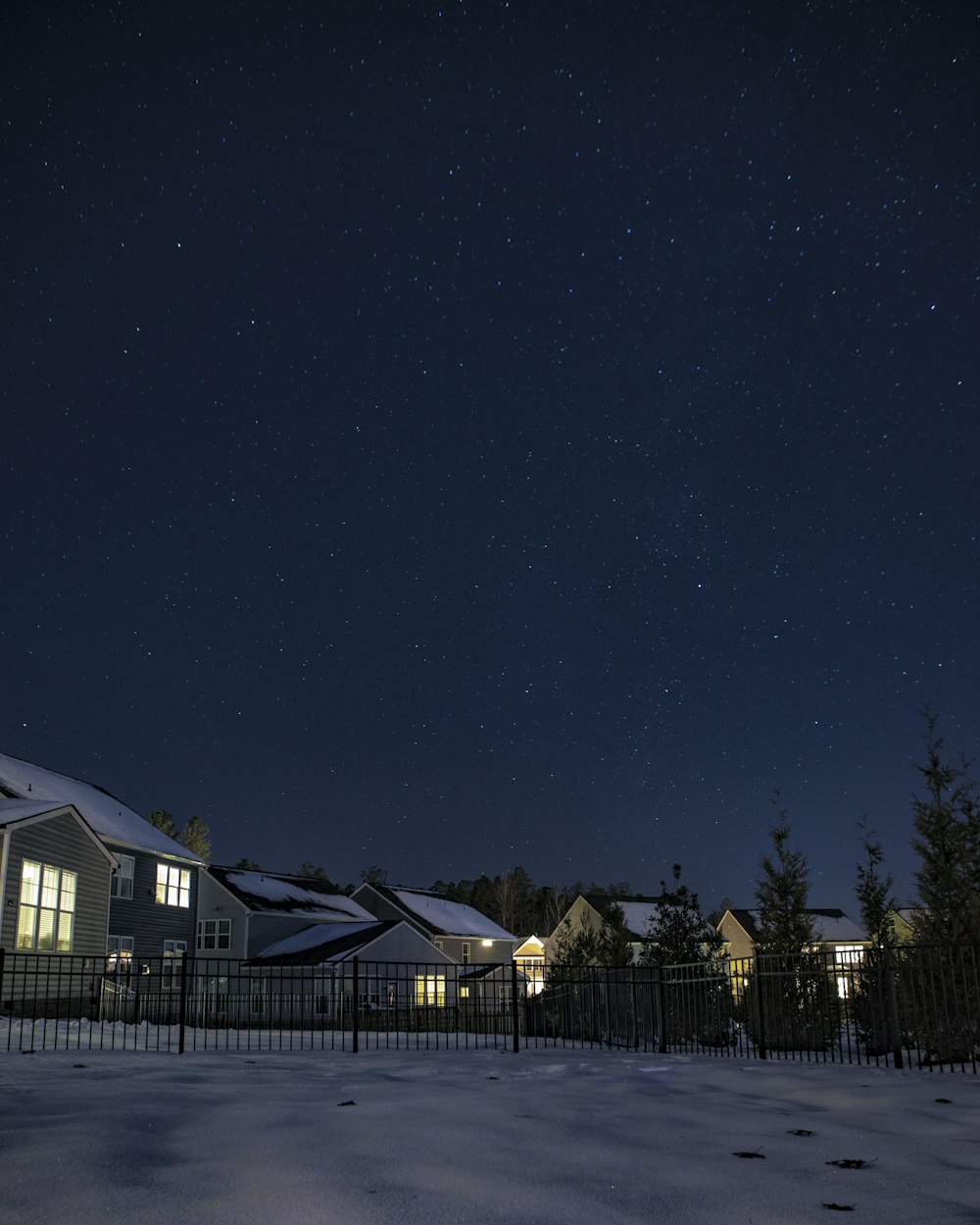 white and brown house under blue sky during night time