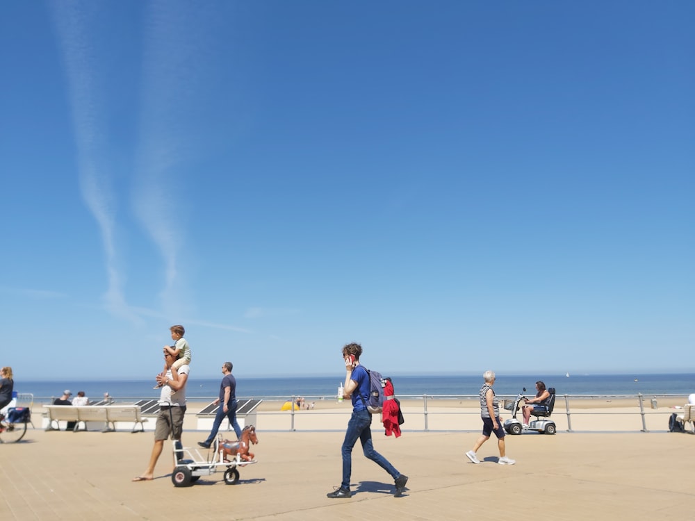 people playing basketball on beach during daytime