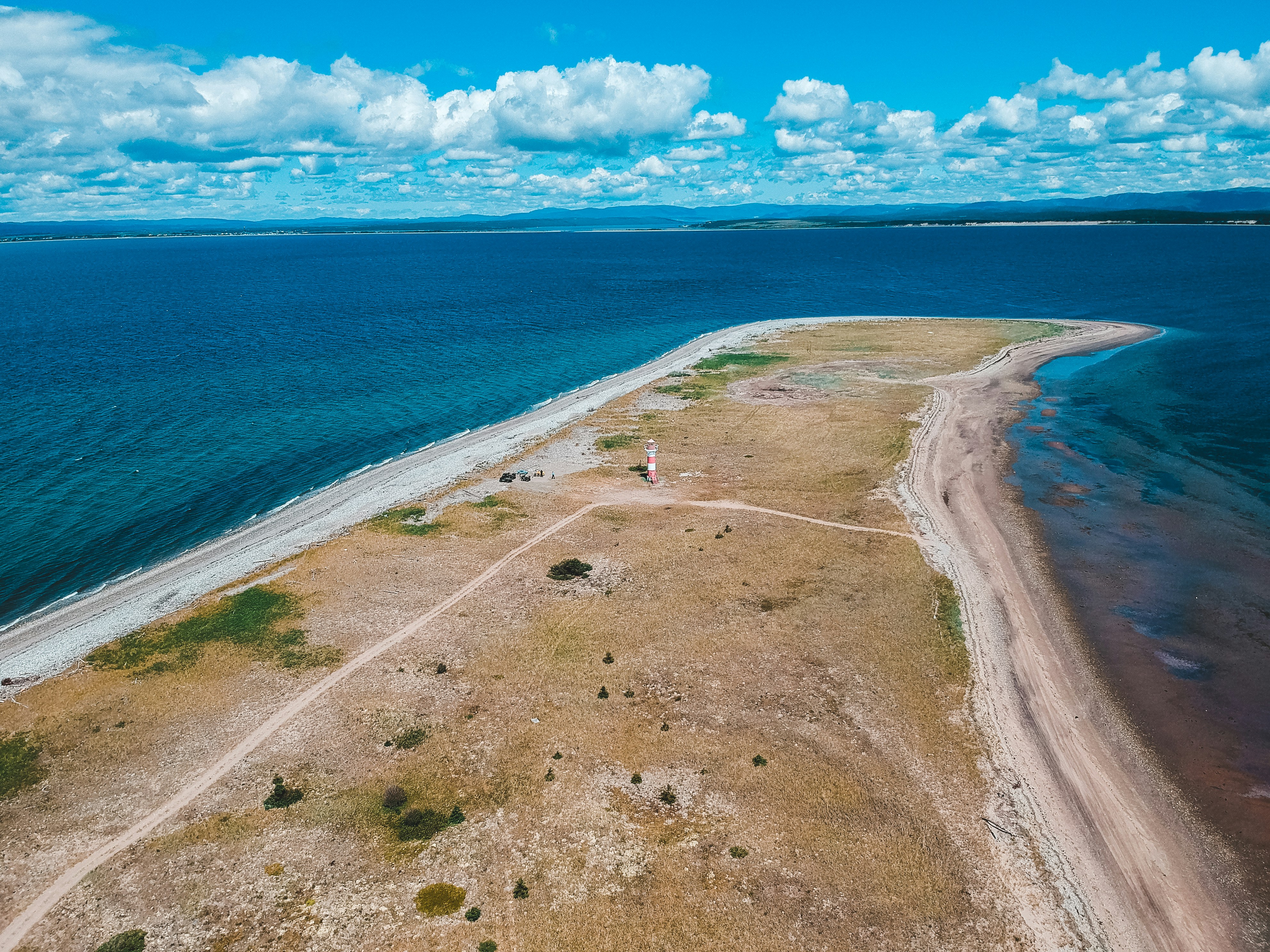 brown sand near body of water during daytime