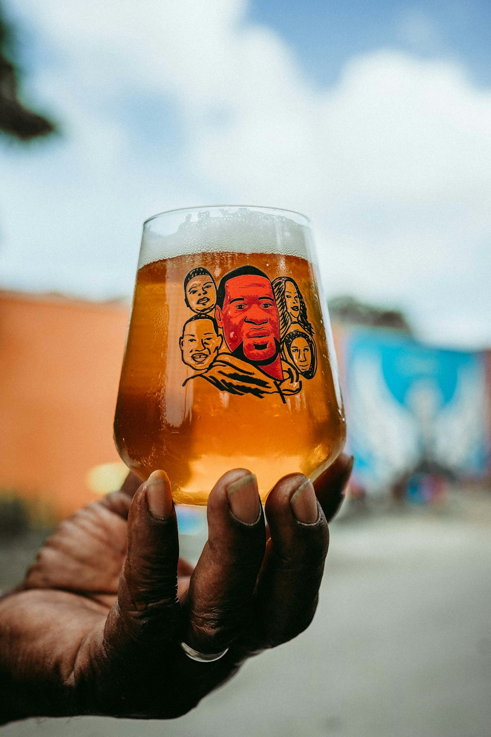 person holding clear drinking glass with beer