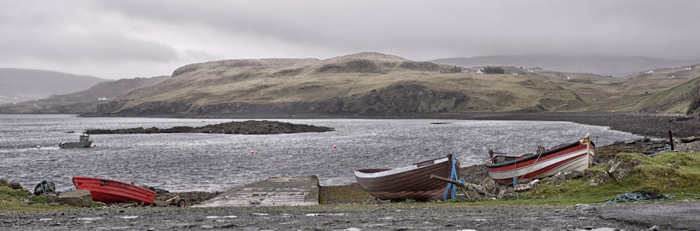 blue and brown boat on brown wooden dock during daytime