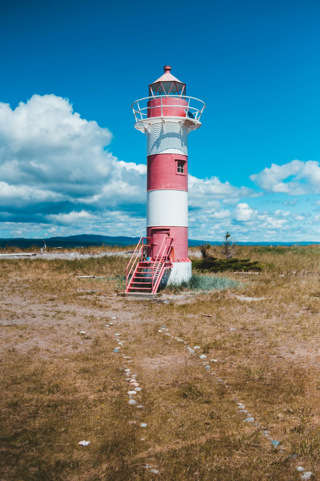 red and white lighthouse under blue sky