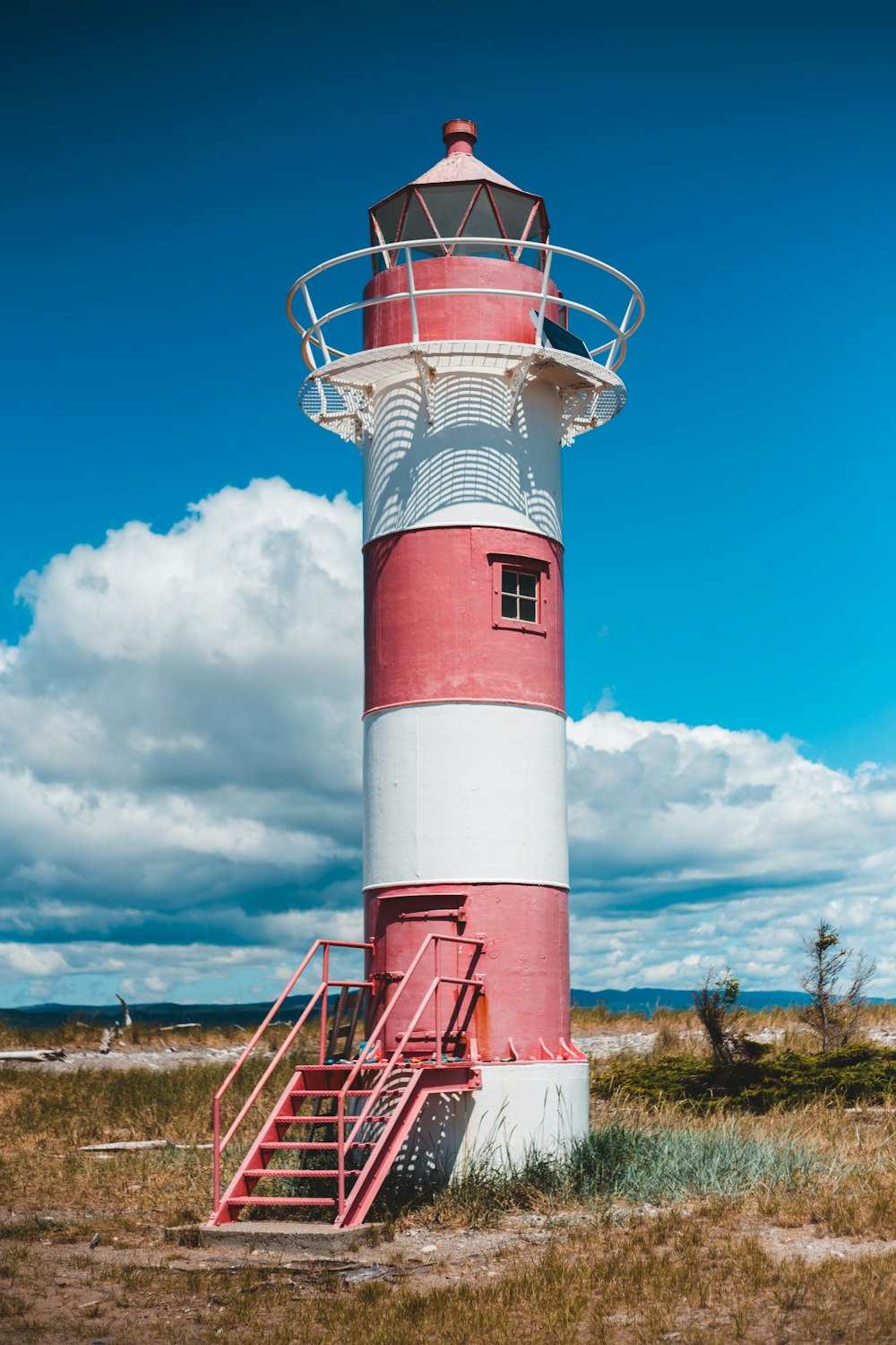 red and white lighthouse under blue sky during daytime