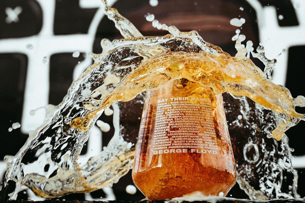 water splash on brown wooden container