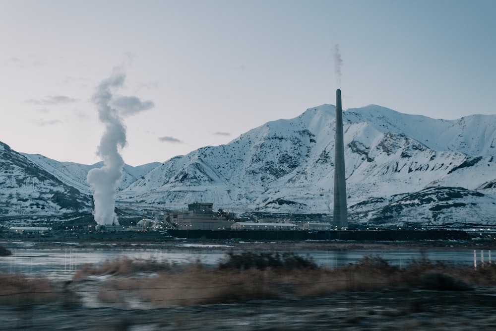 white smoke coming from a white and brown mountain