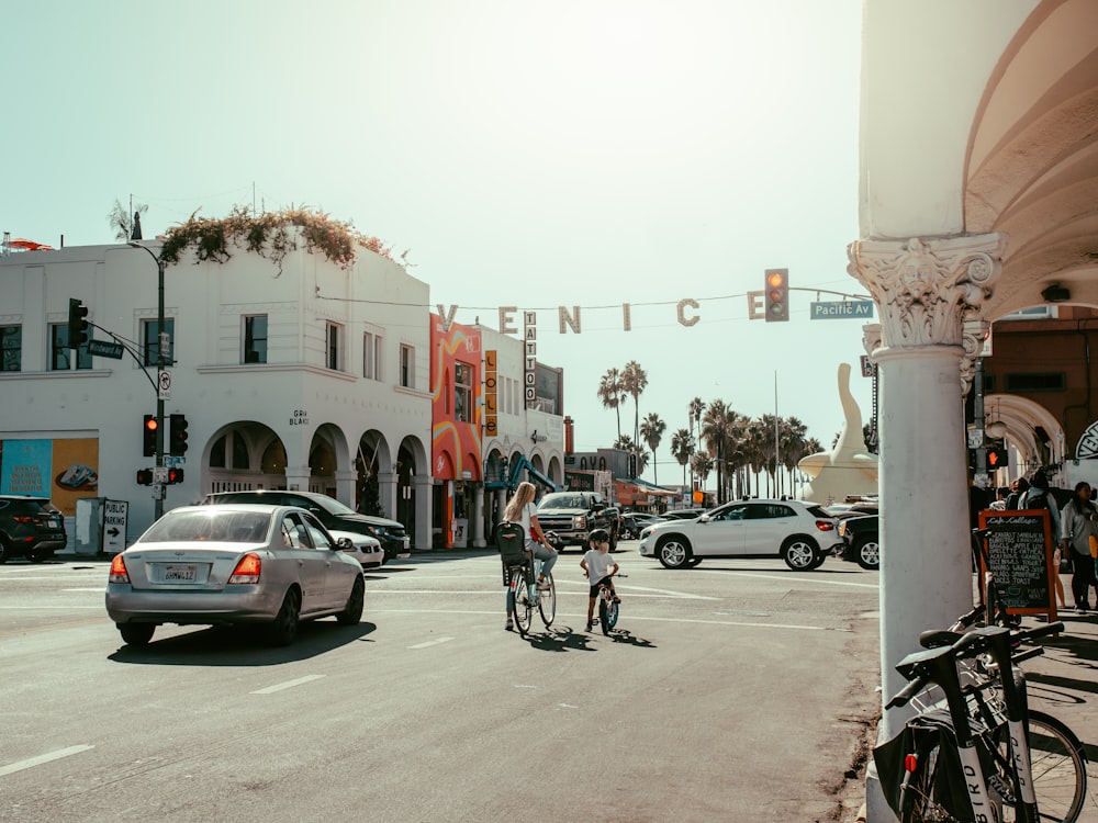 man in black jacket riding bicycle on road during daytime