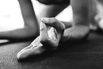 Close-up of hands in a meditative mudra during a klangtrance yoga practice.