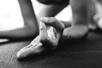 Close-up of hands in a meditative mudra during a klangtrance yoga practice.