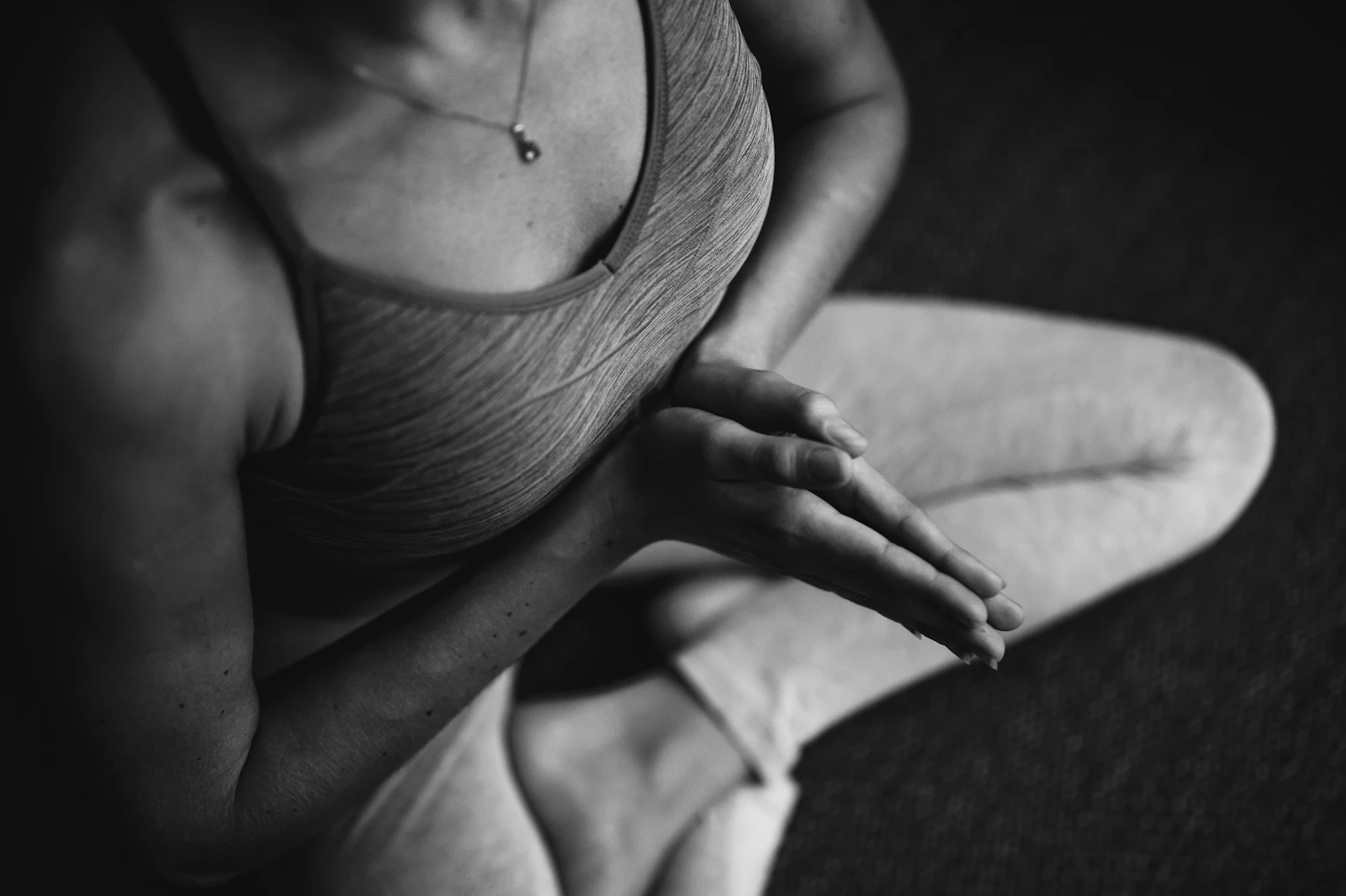 Femme assise en position détendue, mains posées, dans un moment de relaxation