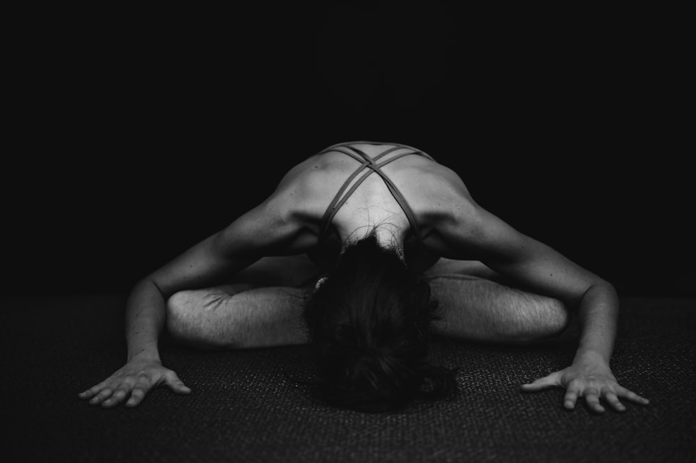 woman in white tank top lying on floor