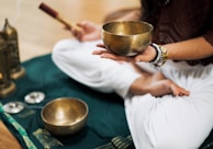 person in white dress shirt holding brown wooden chopsticks