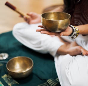 person in white dress shirt holding brown wooden chopsticks