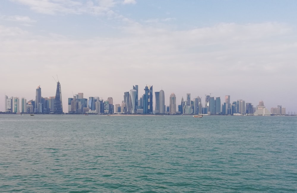 city skyline across body of water during daytime