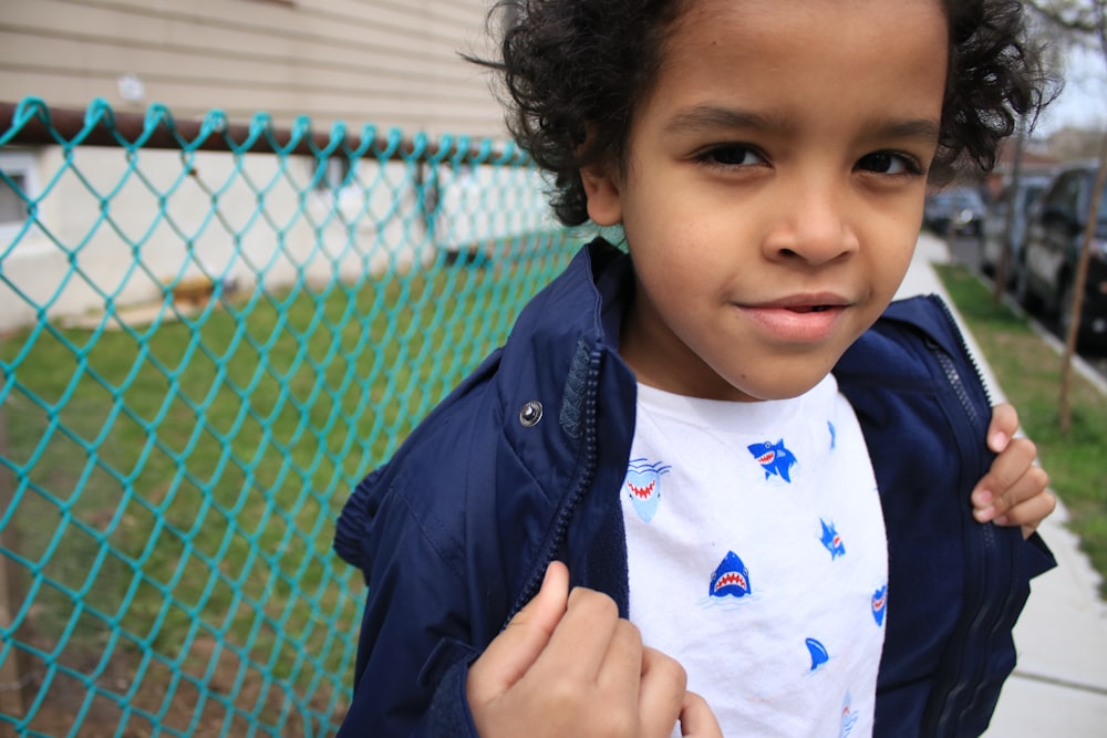 boy in blue and white crew neck shirt and black jacket