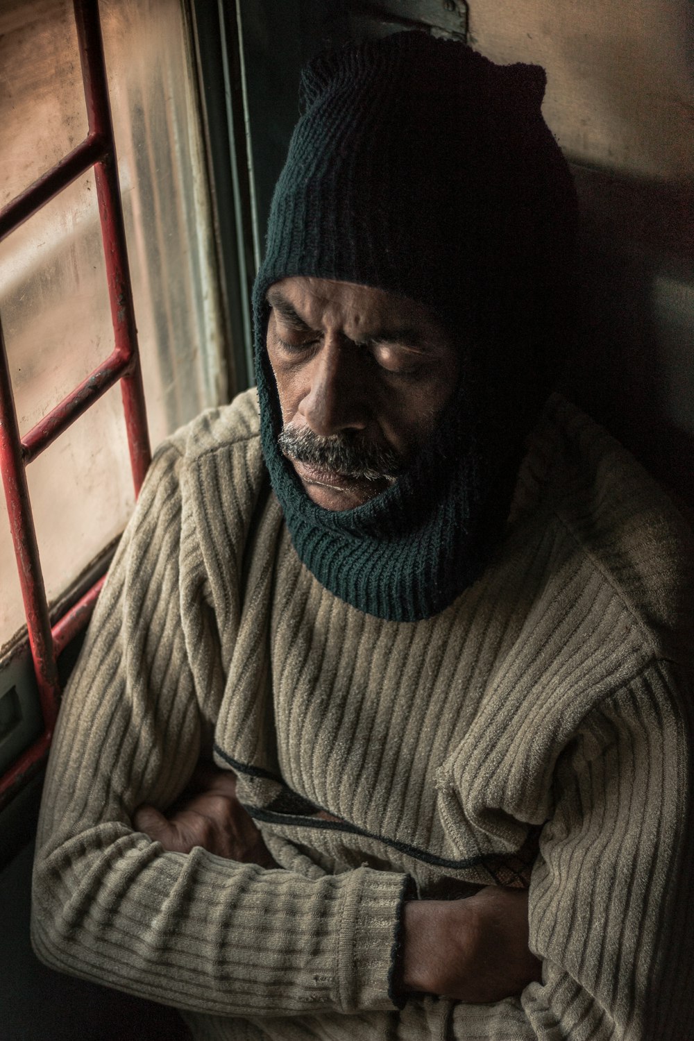 man in gray and white striped sweater