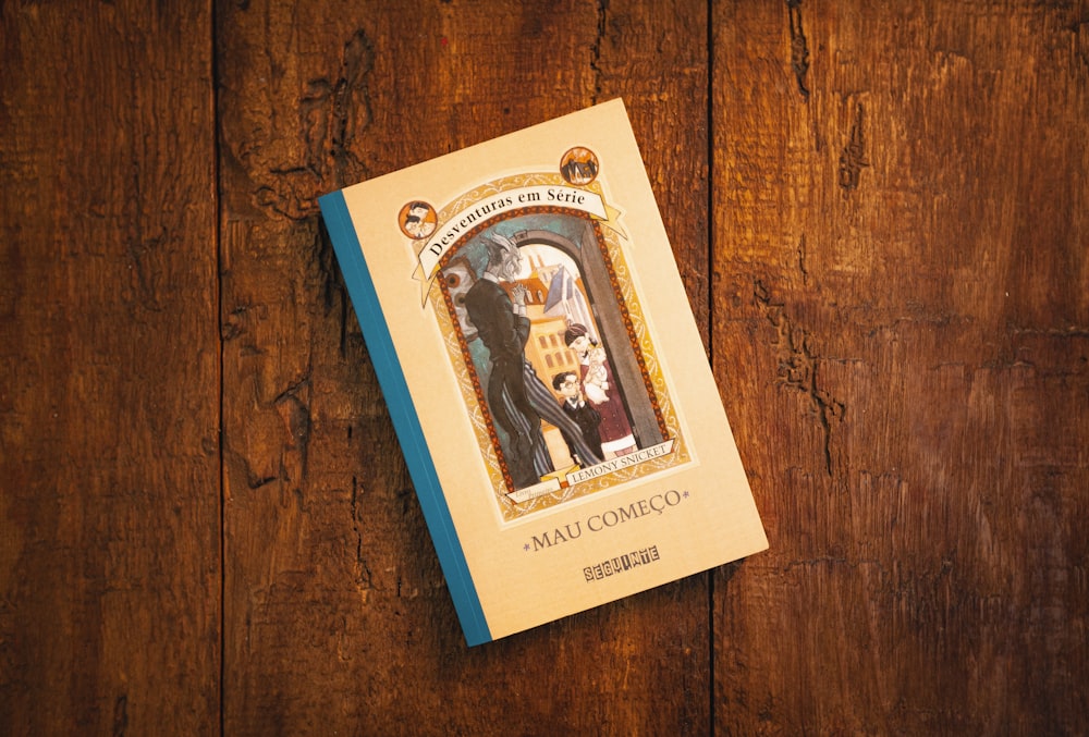 white and blue book on brown wooden table