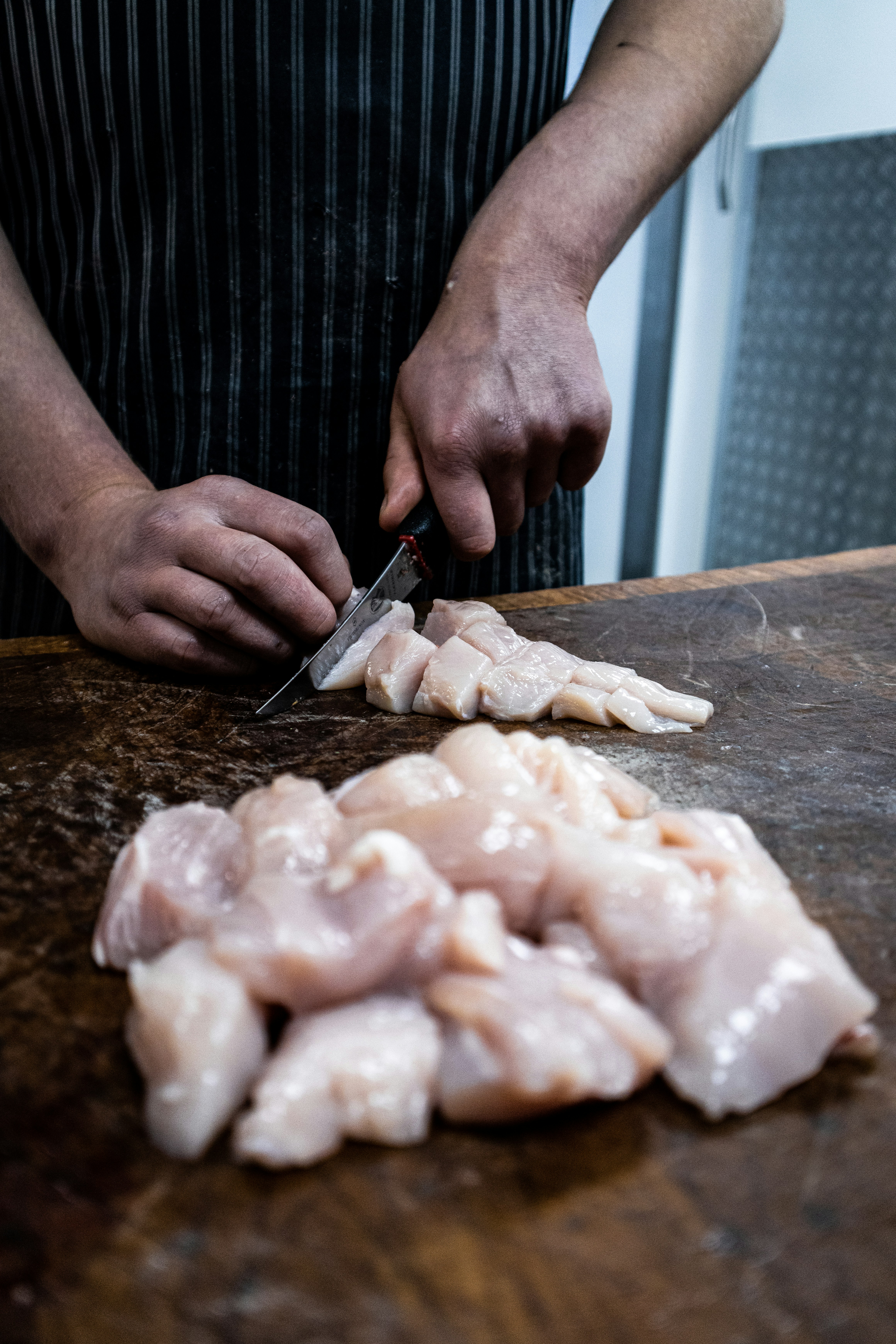 Sliced boneless chicken breast on cutting board