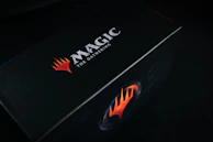 Close-up of a glowing Elite Trainer Box with electric blue and purple neon accents.