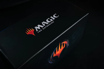 A sleek booster box with vibrant artwork and a secure magnetic closure.