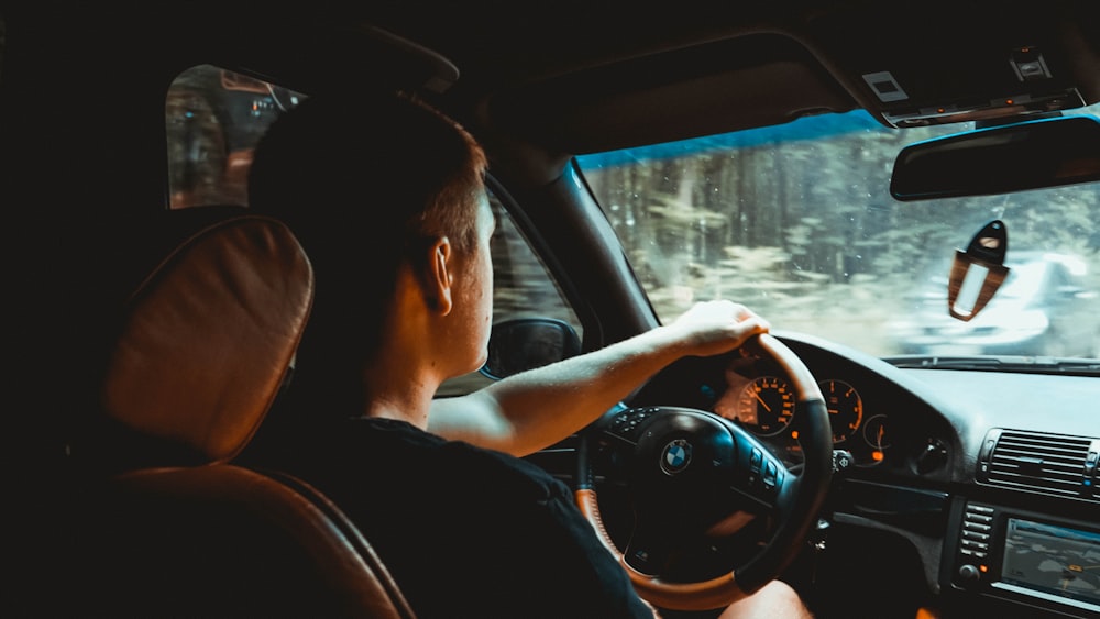 woman driving car during daytime