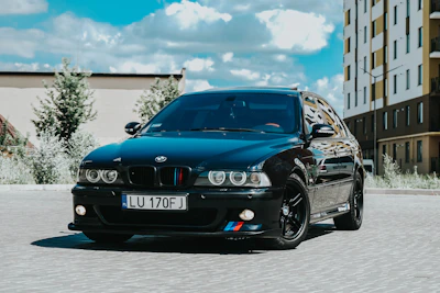 A sleek BMW parked in front of a modern home, ready for its next owner.