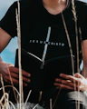 man in black crew neck t-shirt and blue denim jeans