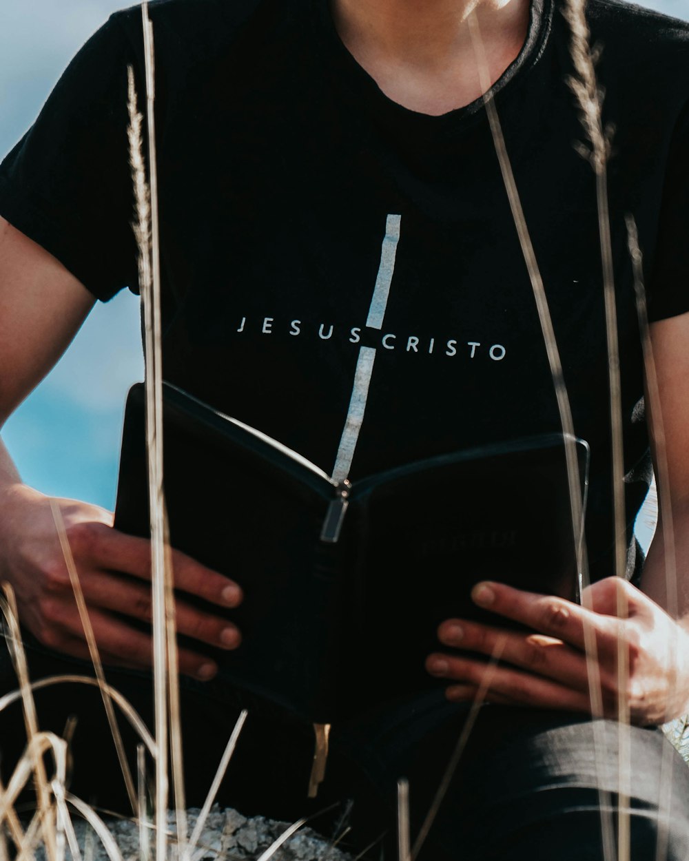 man in black crew neck t-shirt and blue denim jeans