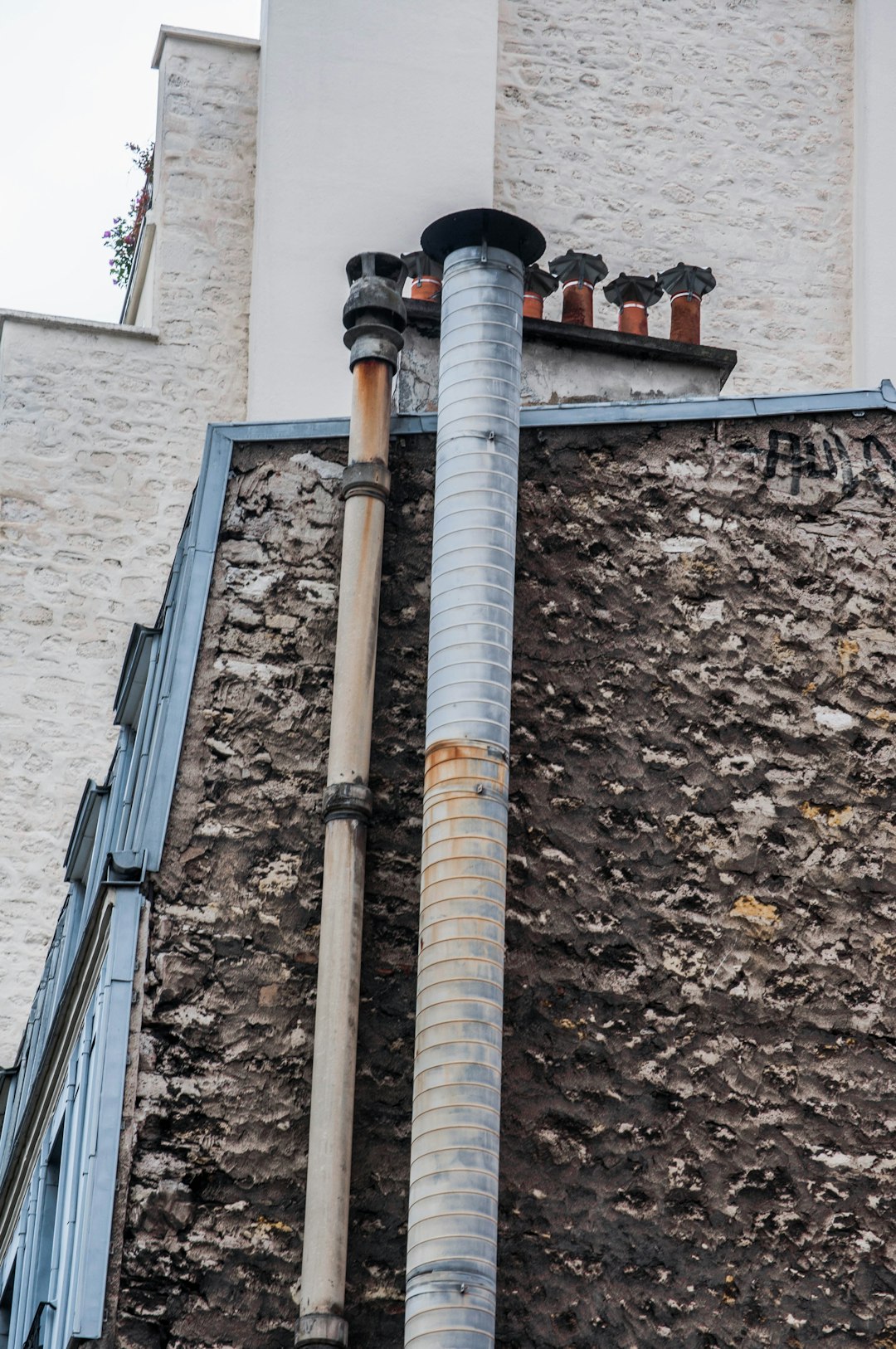 brown and white metal pipe on brown brick wall