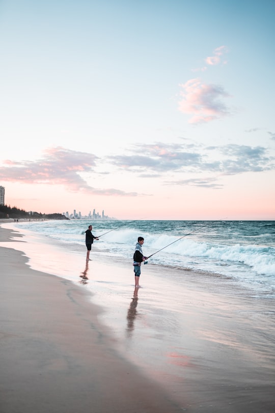 2 women walking on beach during sunset in Burleigh Heads QLD Australia