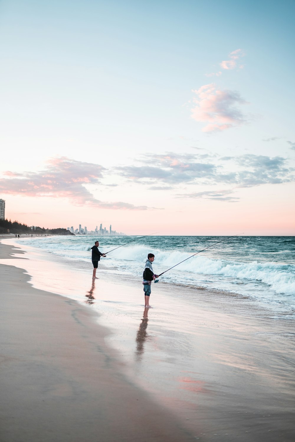 2 women walking on beach during sunset