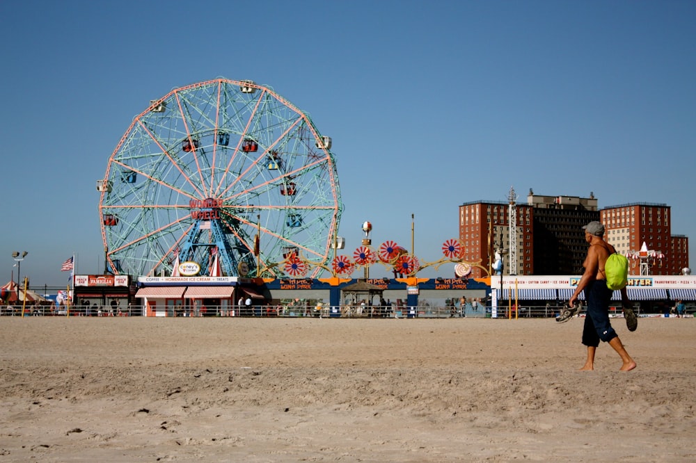 people standing near ferris wheel during daytime