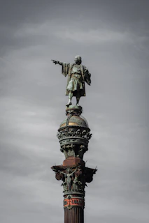 statue of man riding horse under cloudy sky during daytime