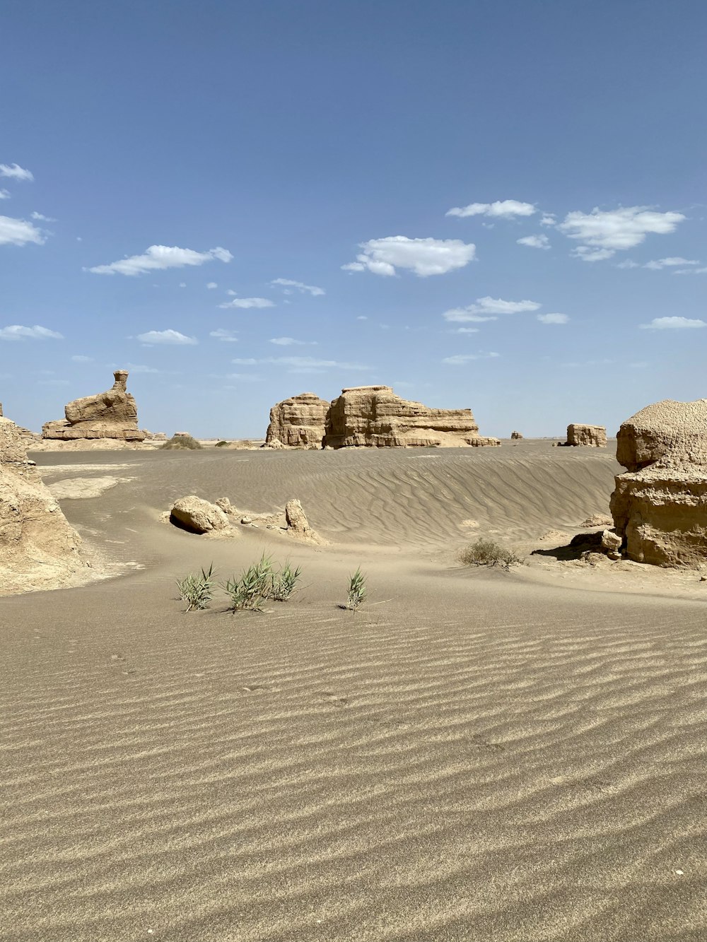 brown rock formation under white clouds during daytime