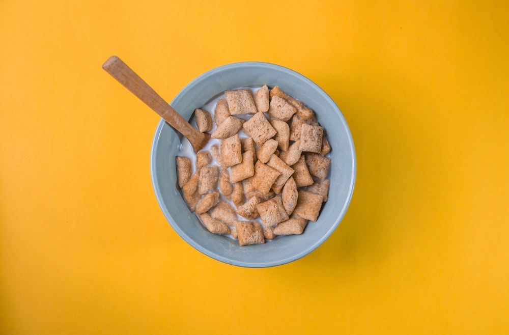 brown peanuts in blue ceramic bowl