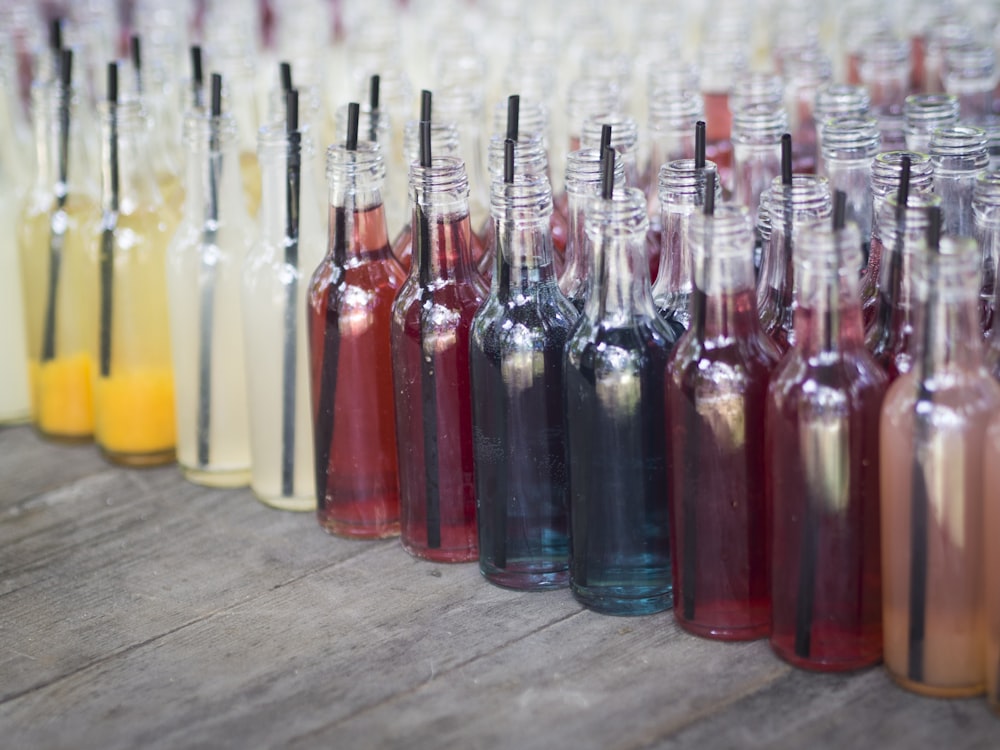 clear glass bottles on brown wooden table