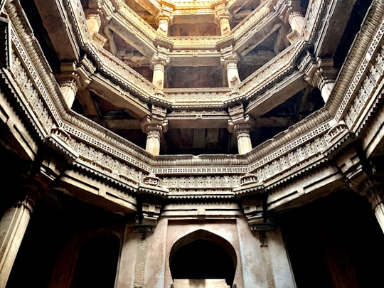 low angle photography of brown concrete building in Adalaj Stepwell India