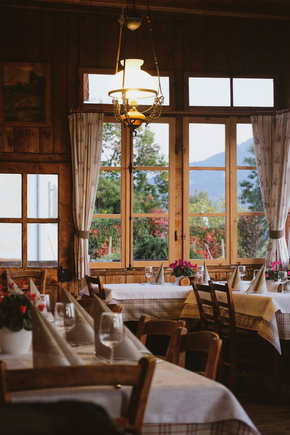 brown wooden table with chairs near window