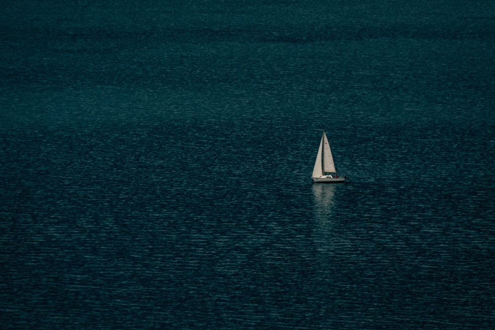 white sailboat on blue sea during daytime