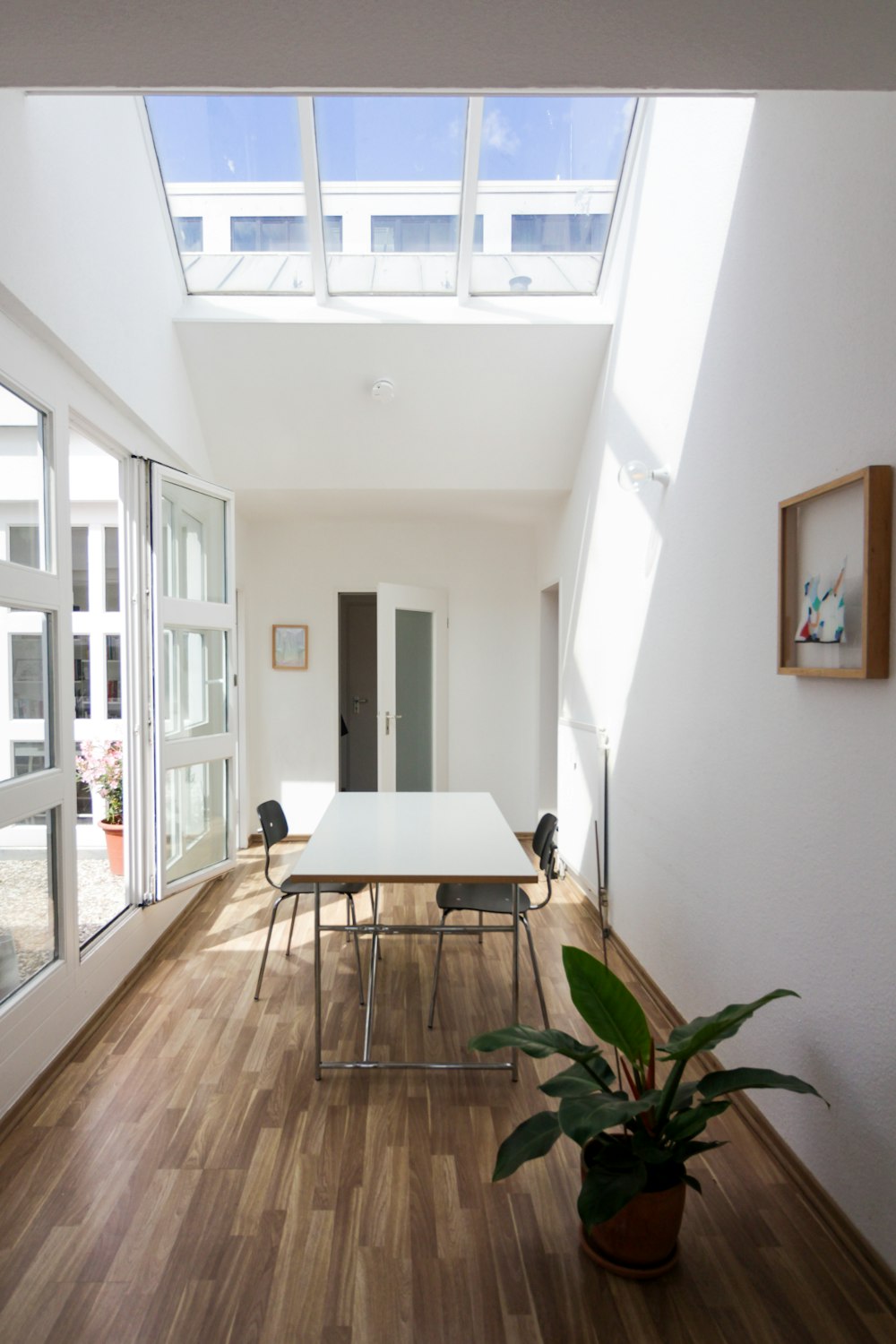 brown wooden table near white wall