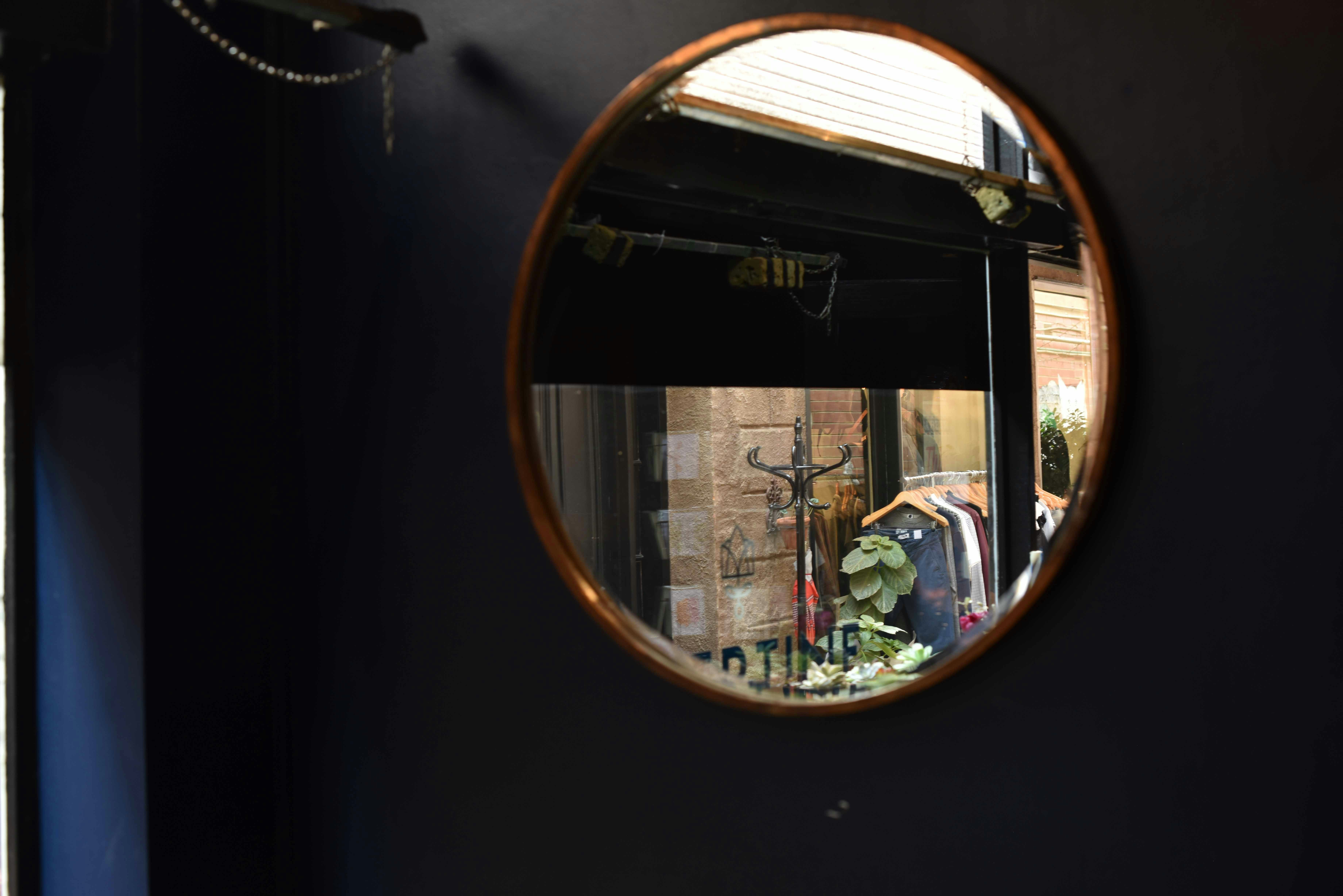 brown wooden framed glass window, Clothing reflected