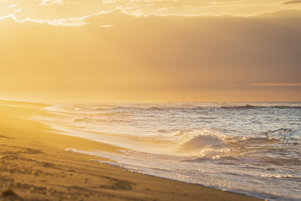 Les vagues de l’océan s’écrasent sur le rivage au coucher du soleil