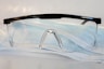 black framed eyeglasses on white textile