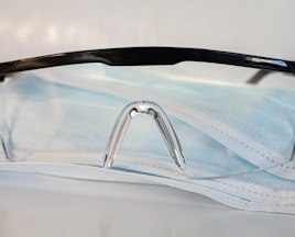 black framed eyeglasses on white textile