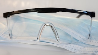 black framed eyeglasses on white textile