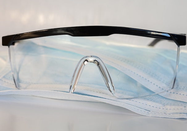 black framed eyeglasses on white textile