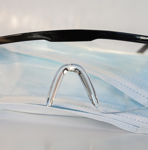 black framed eyeglasses on white textile