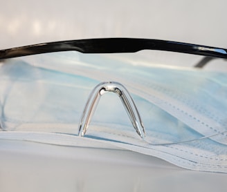 black framed eyeglasses on white textile